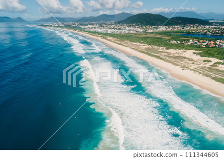 Beach and ocean with surfing waves in Brazil. Aerial view of Campeche beach 111344605