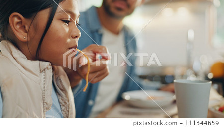 Father, children and a girl eating spaghetti with her family in the dining room of their home together for supper. Food, kids and parents around a table for a meal, bonding over dinner in a house 111344659