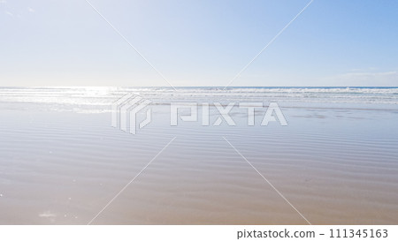 Pismo Beach is strikingly empty during a winter day, offering a serene and peaceful atmosphere with its expansive sandy shore and the soothing sounds of the waves. 111345163