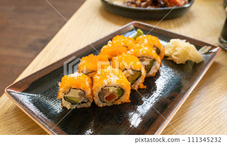 Maki Sushi, California Rolls with Cucumber, Avocado, Raw Fish and Red Tobiko Caviar, Makizushi Maki Sushi, California Rolls with Cucumber, Avocado, Raw Fish and Red Tobiko Caviar, Makizushi 111345232