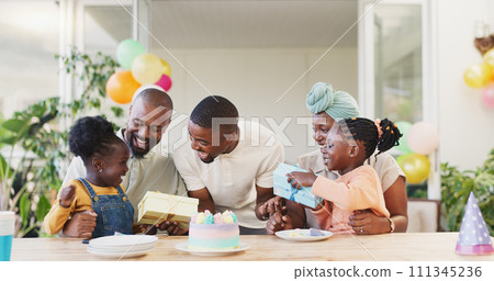 Birthday, present and black family celebrate with children with love, care and surprise. African woman, men and happy kids together at home for a gift, quality time and fun at a party with cake 111345236