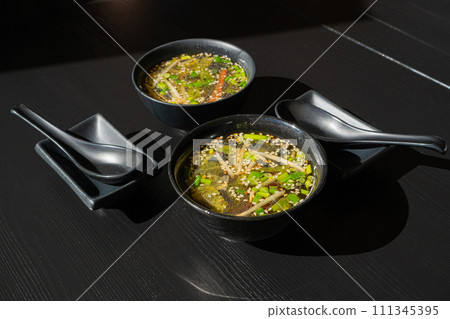 Fish Broth with Greens, Sesame Seeds and Herbs 111345395