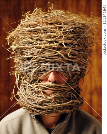 Man head encased in nest of twigs. AI-generated item 111345645