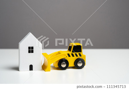 The bulldozer intends to demolish the house. Tearing down a house. Making way for future developments. The bulldozer intends to demolish the house. Tearing down a house. Making way for future developments. 111345713