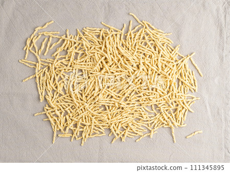 Raw Trofie Pasta, Dry Italian Macaroni, Traditional Genoa Food, Raw Noodle, Modern Ligurian Cuisine Raw Trofie Pasta, Dry Italian Macaroni, Traditional Genoa Food, Raw Noodle, Modern Ligurian Cuisine 111345895