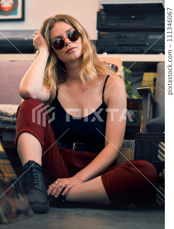 Grunge fashion, punk woman and rock hipster, retro model and confident female with glasses on floor. Portrait of young gen z, cool girl and attitude in creative style, urban fashion and trendy youth 111346067