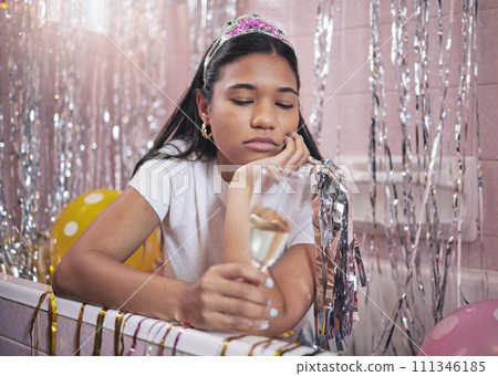 Birthday girl, sad and champagne while feeling bored, upset and disappointed while sitting alone in bathtub lonely and depressed. Unhappy, boring and abandoned woman during quarantine celebration 111346185
