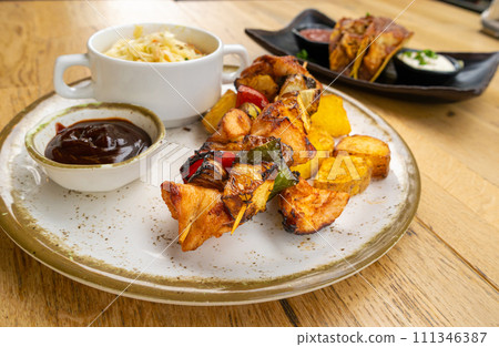 Poultry Shish Kebab, Barbecue Shashlik with Meat and Vegetables, Fruits, Peppers, Onions and Pineapple 111346387