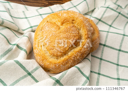 Heart on Wheat Bread, Heart Shaped Bun on Wooden Table 111346767