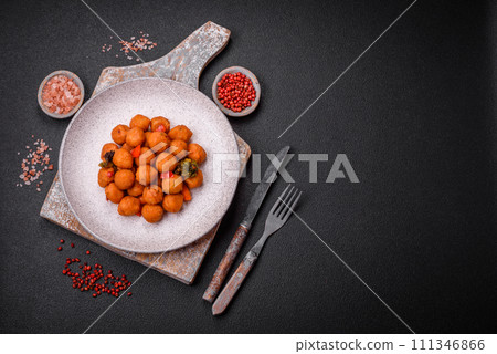 Delicious fried potato balls with vegetables, salt, spices and herbs 111346866