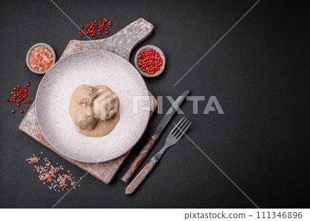 Delicious meatballs from minced chicken or turkey with sour cream sauce 111346896