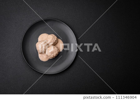 Delicious meatballs from minced chicken or turkey with sour cream sauce 111346904