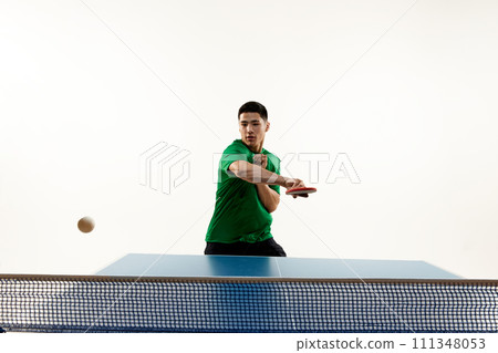 Athletic table tennis stance from competitive Asian sportsman, player in sportswear in motion against white studio background. Athletic table tennis stance from competitive Asian sportsman, player in sportswear in motion against white studio background. 111348053