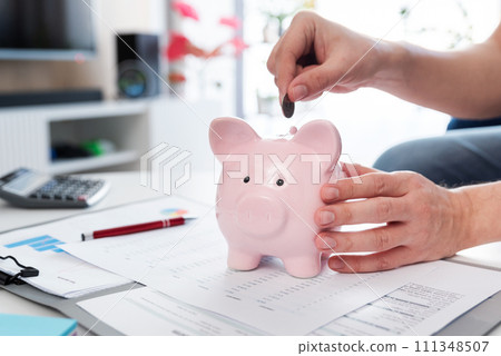 Savings concept with man putting coin 111348507