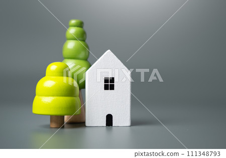 Cute house with trees, figurines. Greenery with trees. Comfort and serenity 111348793