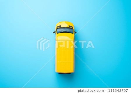 Yellow delivery van top view. Copy space. Delivery of goods and cargo within the city. Delivering goods and services. E-commerce, retail, or other industries on efficient distribution networks. Yellow delivery van top view. Copy space. Delivery of goods and cargo within the city. Delivering goods and services. E-commerce, retail, or other industries on efficient distribution networks. 111348797