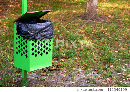 Garbage can bin basket for animal feces in a city park Garbage can bin basket for animal feces in a city park 111349199
