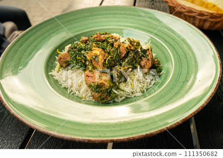Pilau on Green Plate, Beef Pilaf, Traditional Asian Dish Plov also known as Polow, Pilav, Pallao, Pulao, Palaw Pilau on Green Plate, Beef Pilaf, Traditional Asian Dish Plov also known as Polow, Pilav, Pallao, Pulao, Palaw 111350682