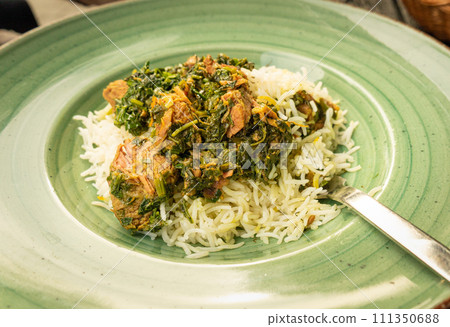 Pilau on Green Plate, Beef Pilaf, Traditional Asian Dish Plov also known as Polow, Pilav, Pallao, Pulao, Palaw Pilau on Green Plate, Beef Pilaf, Traditional Asian Dish Plov also known as Polow, Pilav, Pallao, Pulao, Palaw 111350688
