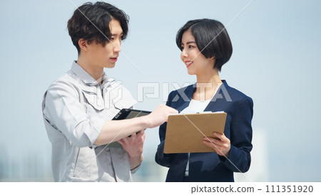 Site supervisor and business woman looking at tablet at construction site 111351920