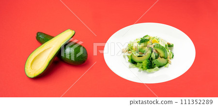 Green Salad with Avocado, Cucumber and Nuts on White Plate Green Salad with Avocado, Cucumber and Nuts on White Plate 111352289
