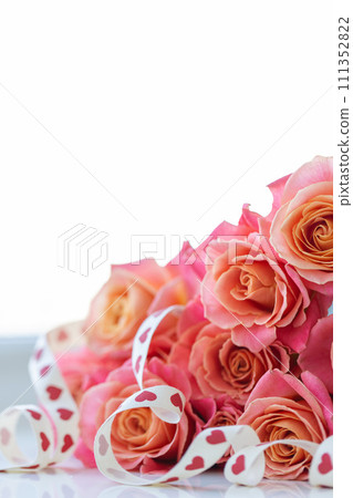 Gift ribbon with red hearts on the roses on a white background. Saint Valentine concept. Gift ribbon with red hearts on the roses on a white background. Saint Valentine concept. 111352822