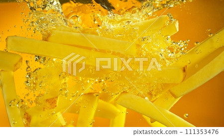 Freeze Motion of French Fries Floating in Cooking Oil. 111353476