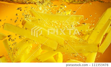 Freeze Motion of French Fries Floating in Cooking Oil. 111353478