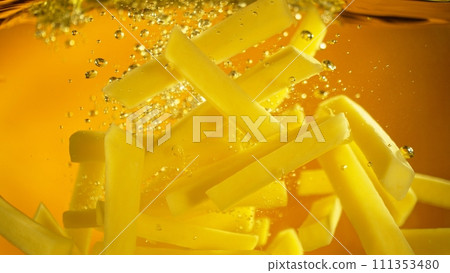 Freeze Motion of French Fries Floating in Cooking Oil. 111353480