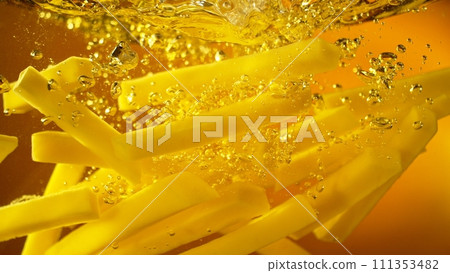 Freeze Motion of French Fries Floating in Cooking Oil. 111353482