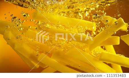 Freeze Motion of French Fries Floating in Cooking Oil. 111353483