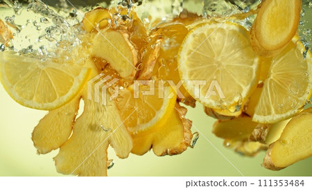 Freeze Motion of Ginger and Lemon Slices Falling into Water. 111353484