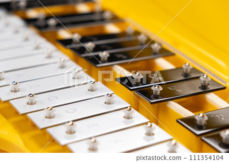 Metallophone musical percussion instrument with metal plates close-up Metallophone musical percussion instrument with metal plates close-up 111354104