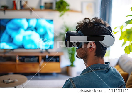 young man enjoying virtual reality in his living room 111355121
