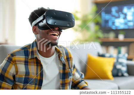 young man enjoying virtual reality in his living room 111355122