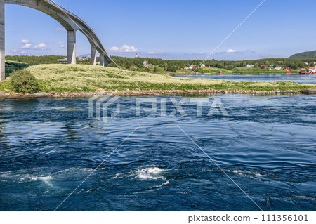 Powerful Saltstraumen currents weave textures, bridged by an arc against a tranquil landscape Powerful Saltstraumen currents weave textures, bridged by an arc against a tranquil landscape 111356101