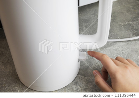 Includes an electric kettle for boiling water. Energy saving concept, expensive electricity Includes an electric kettle for boiling water. Energy saving concept, expensive electricity 111356444