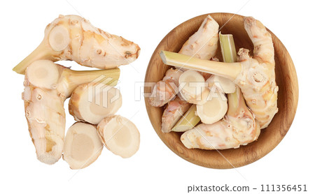 Fresh galangal root in wooden bowl isolated on white background with full depth of field. Top view. Flat lay Fresh galangal root in wooden bowl isolated on white background with full depth of field. Top view. Flat lay 111356451