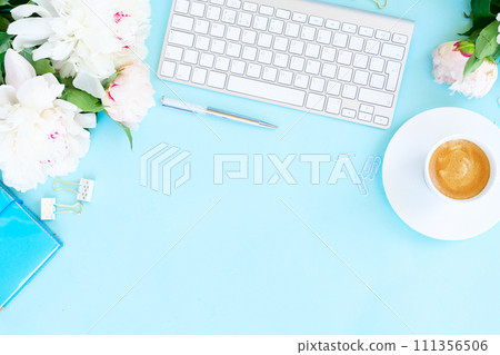 Flat lay home office workspace on blue Flat lay home office workspace on blue 111356506