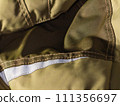 Khaki workwear protective clothing reflector inserts close-up details. 111356697