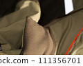 Khaki workwear protective clothing reflector inserts close-up details. 111356701