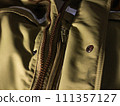 Zipper on beige workwear protective clothing in close-up. 111357127