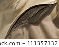Zipper on beige workwear protective clothing in close-up. 111357132