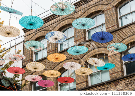 Umbrellas hanging over street in Chinatown in London 111358369