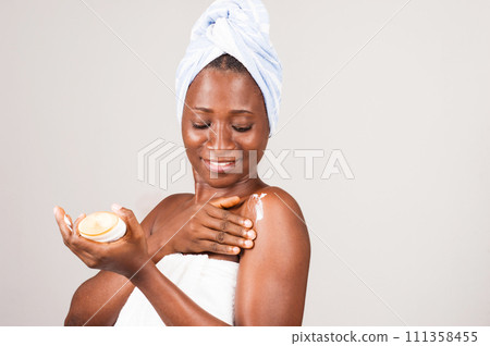 beautiful african woman putting on ointment. 111358455