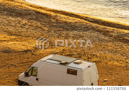 Camper van on beach in the morning Camper van on beach in the morning 111358788