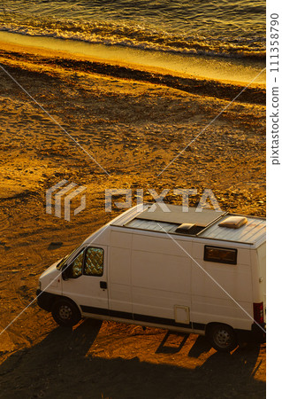 Camper van on beach at sunrise 111358790