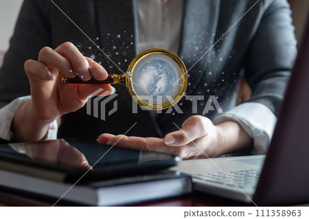 Manager shows global network through magnifying glass. Manager shows global network through magnifying glass. 111358963