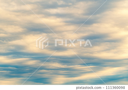 Background of mottled clouds covering the blue sky, emphasis on warm and cool colors, bright Background of mottled clouds covering the blue sky, emphasis on warm and cool colors, bright 111360098