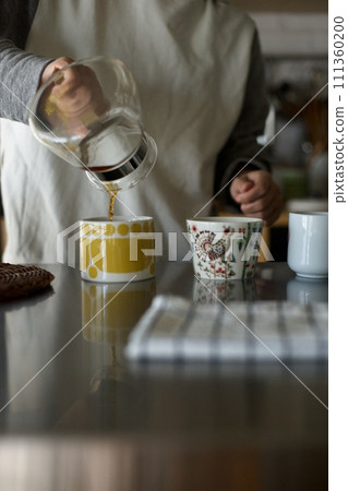 Putting dripped coffee into a cup Putting dripped coffee into a cup 111360200